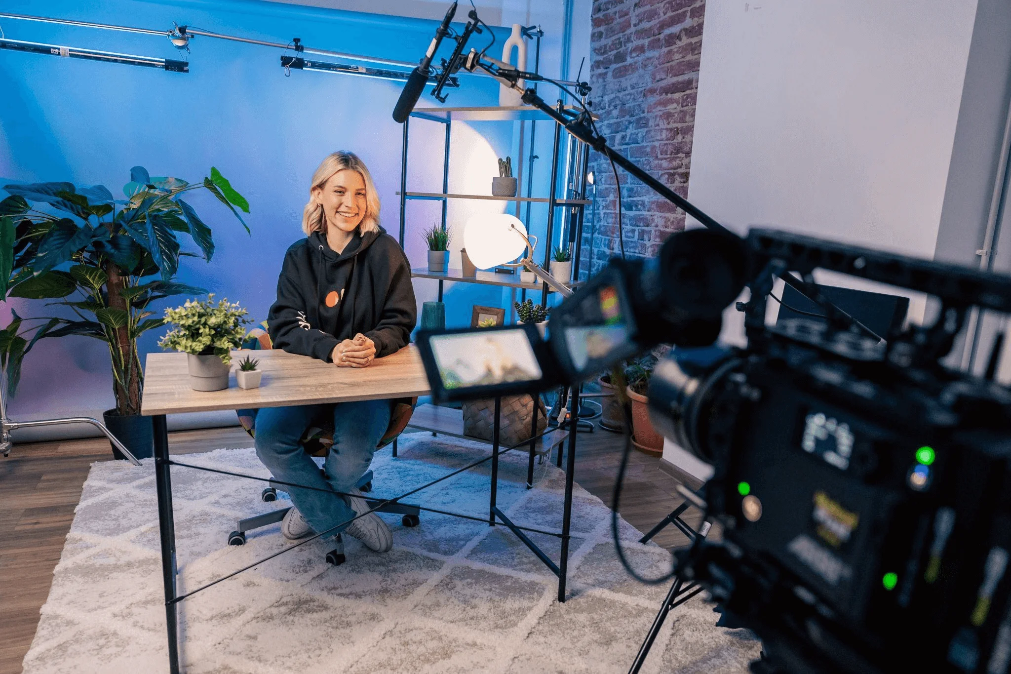 A person sitting at a desk surrounded by digital tools, symbolizing the creative process behind a professional video animation service.